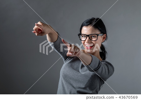 Young woman pointing at something Young woman pointing at something 43670569