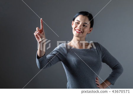 Young woman pointing at something 43670571