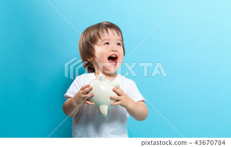 Toddler boy with a piggy bank Toddler boy with a piggy bank 43670784