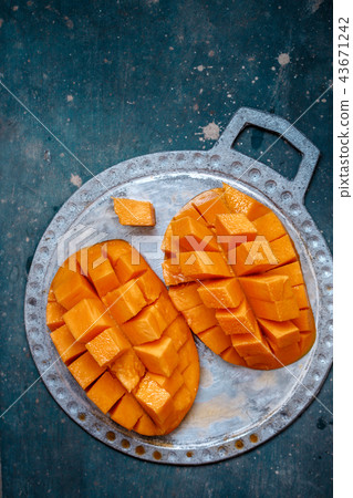 Juicy, ripe mango on a plate Juicy, ripe mango on a plate 43671242