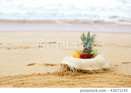 a hat with fruit on a background of a seascape a hat with fruit on a background of a seascape 43671245