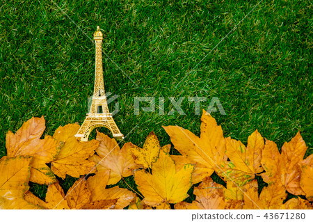 autumn maple leaves and eiffel tower souvenir 43671280