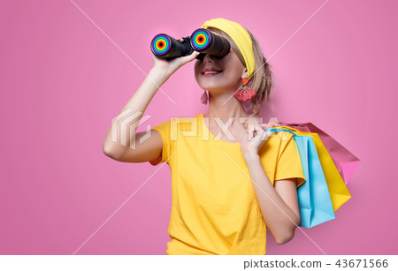 girl holding colorful bags and binoculars 43671566