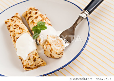 thin crepes rolled pancakes with sour cream mint 43672397