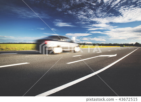 Car on asphalt road in beautiful spring day 43672515