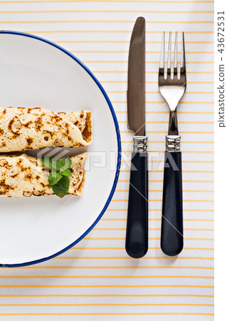 thin pancakes rolled crepes mint on a plate with 43672531