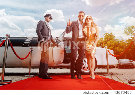 Couple arriving with limousine walking red carpet 43673493
