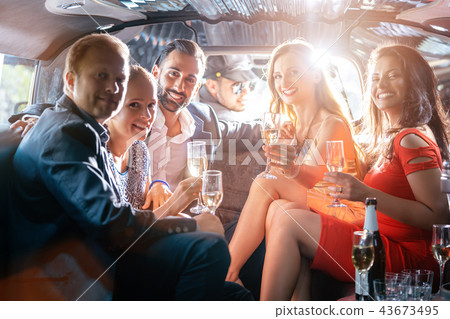 Group of party people in a limo drinking 43673495