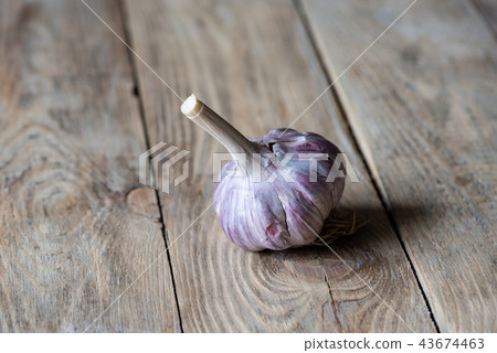 Garlic on a wooden background. Country style. Garlic on a wooden background. Country style. 43674463