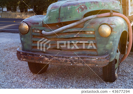 Vintage really old blue, green turquoise truck parked by the road 43677294