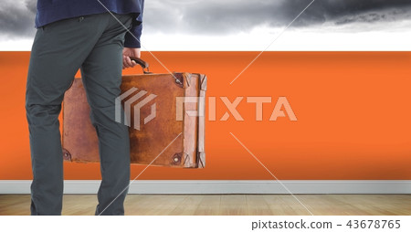 Businessman with briefcase and orange wall Businessman with briefcase and orange wall 43678765