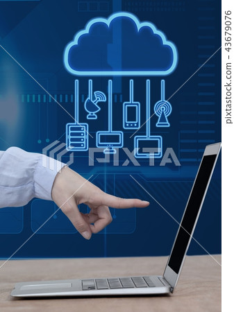 Hand pointing at laptop with cloud icon and hanging connection devices and technology background Hand pointing at laptop with cloud icon and hanging connection devices and technology background 43679076