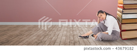 Business woman sitting on the floor next to a pile of books 43679182
