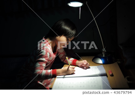 Portrait Asian girls doing homework under light 43679794