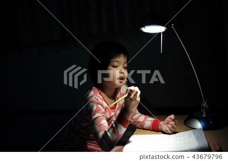 Portrait Asian girls doing homework under light Portrait Asian girls doing homework under light 43679796