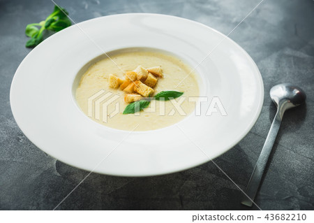Homemade pea soup with grilled bread and leaf 43682210