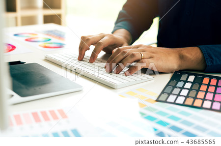 Graphic designer typing keyboard on desk Graphic designer typing keyboard on desk 43685565