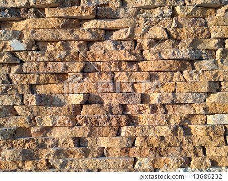 Decorative bricks wall with stone like finish 43686232