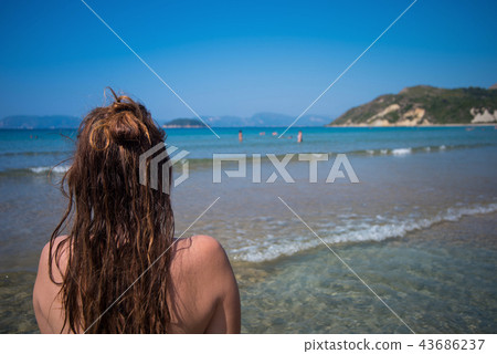 Woman looking into the sea. Woman looking into the sea. 43686237