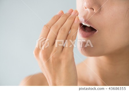 Young Japanese woman doing bad breath check Young Japanese woman doing bad breath check 43686355