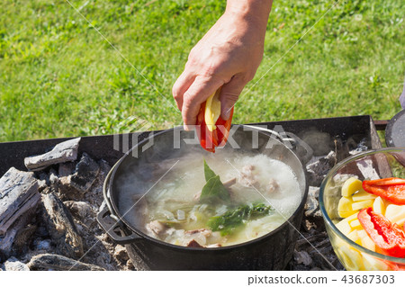 Shurpa soup in large cast-iron cauldron. Cooking. Shurpa soup in large cast-iron cauldron. Cooking. 43687303