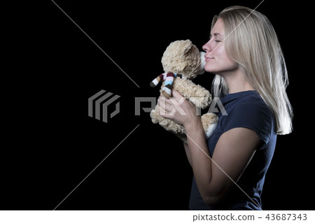 Woman with teddy bear Woman with teddy bear 43687343