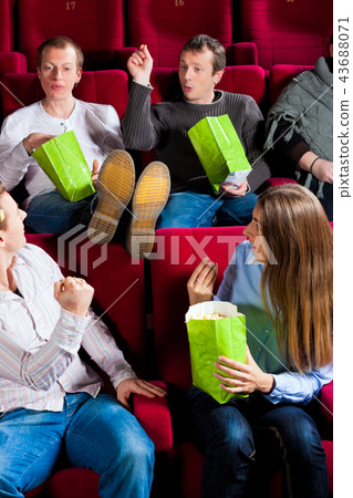 People eating popcorn in theatre People eating popcorn in theatre 43688071