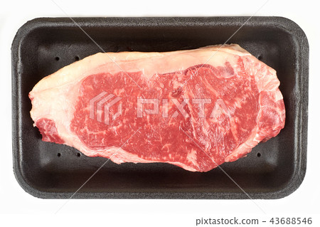 Raw steak in package. Isolated on white background. Raw steak in package. Isolated on white background. 43688546