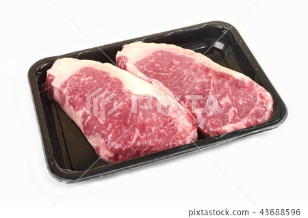 Raw steak in an airtight vacuum package on a white background. 43688596