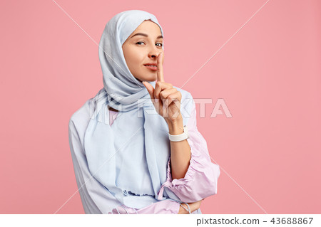 Happy arab woman in hijab. Portrait of smiling girl, posing at studio background 43688867