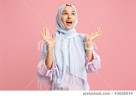 Happy arab woman in hijab. Portrait of smiling girl, posing at studio background Happy arab woman in hijab. Portrait of smiling girl, posing at studio background 43688934