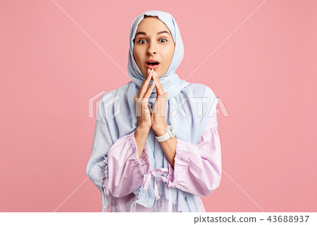Happy arab woman in hijab. Portrait of smiling girl, posing at studio background Happy arab woman in hijab. Portrait of smiling girl, posing at studio background 43688937