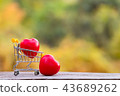 Red heart shape in mini shopping cart on wooden  43689262
