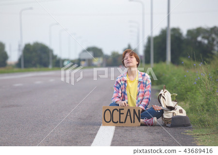 girl with a guitar hitch-hiking 43689416