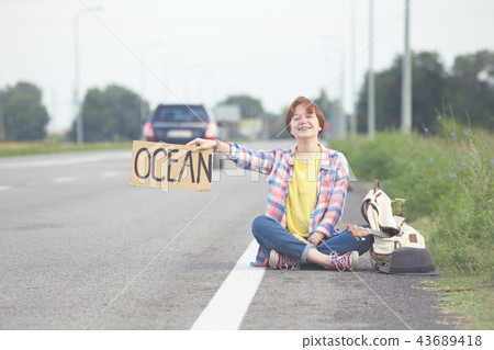 girl with a guitar hitch-hiking girl with a guitar hitch-hiking 43689418
