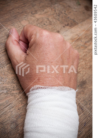 closeup of wrist sprain on wooden table closeup of wrist sprain on wooden table 43689542