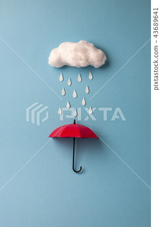 Red umbrella with rain clouds on blue background 43689641