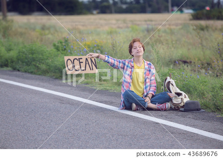girl with a guitar hitch-hiking girl with a guitar hitch-hiking 43689676