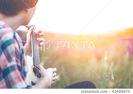 hands playing a guitar close-up 43689974