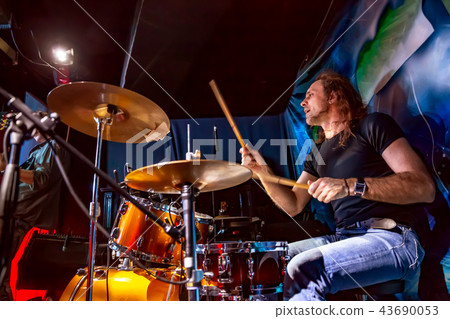 Drummer playing on drum set on stage. Drummer playing on drum set on stage. 43690053