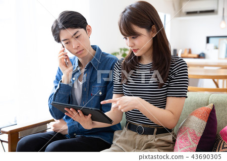 Couple making a request for data by phone Couple making a request for data by phone 43690305