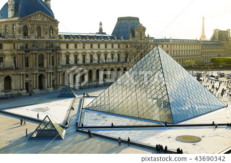 People walking in Louvre near glass pyramid, Paris, France. 43690342