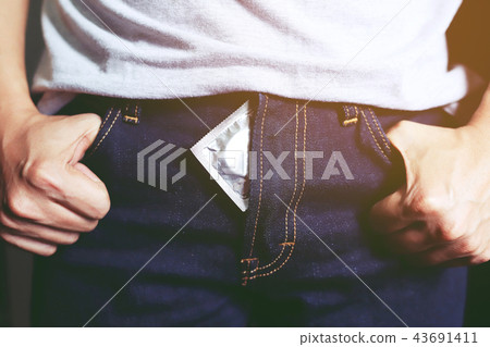 young man condom in jeans between her legs  43691411