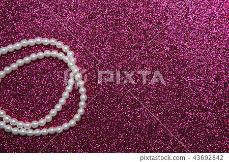 Pearl necklace on a hot pink background 43692842