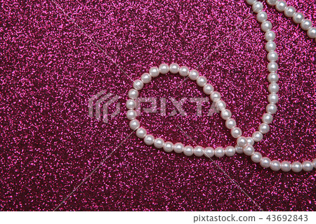 Pearl necklace on a hot pink background 43692843