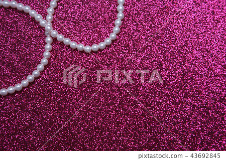 Pearl necklace on a hot pink background 43692845