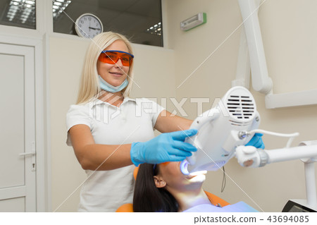 teeth whitening by dental UV whitening device, 43694085