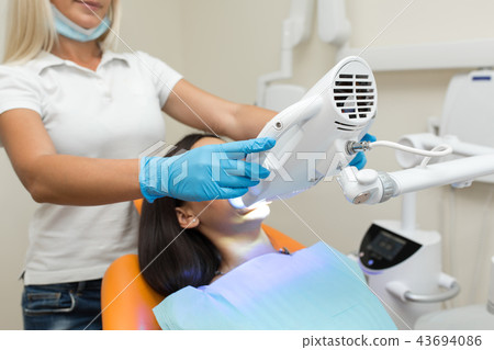 teeth whitening by dental UV whitening device teeth whitening by dental UV whitening device 43694086