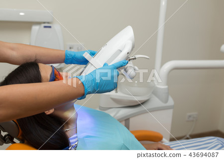 teeth whitening by dental UV whitening device, 43694087