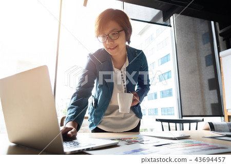 Happy Asian Designer working. 43694457